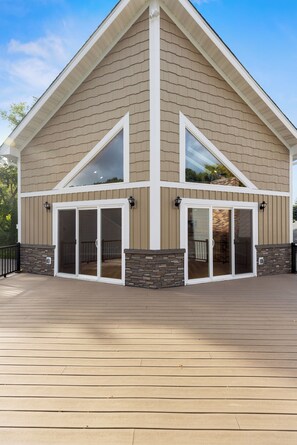 A two-story building with a gabled roof and a covered patio area. - Basement Pool-Spacious Lakehouse 4-bedroom house in serene Prior Lake (Prior Lake)