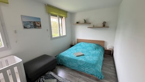 A small, tidy room with a bed, a bench, a crib, and a window with a view of the outdoors. - New Listing (Velaux)
