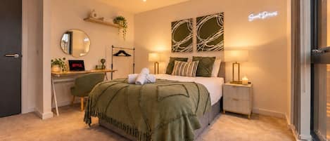 A modern bedroom with a bed, bedside tables, a desk, a mirror, and a wall-mounted shelf with plants.