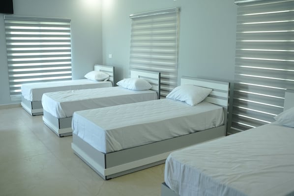 A hotel room with two single beds, a large window with blinds, and a modern design. - CLOUDWOOD RESORT (Sulthan Bathery)