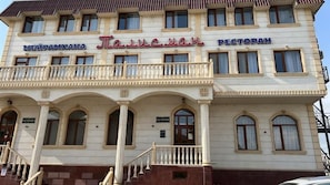 A building with multiple signs, including 'MEYRAMXANA' and 'PECTOPAH'. - Talisman (Aktau)