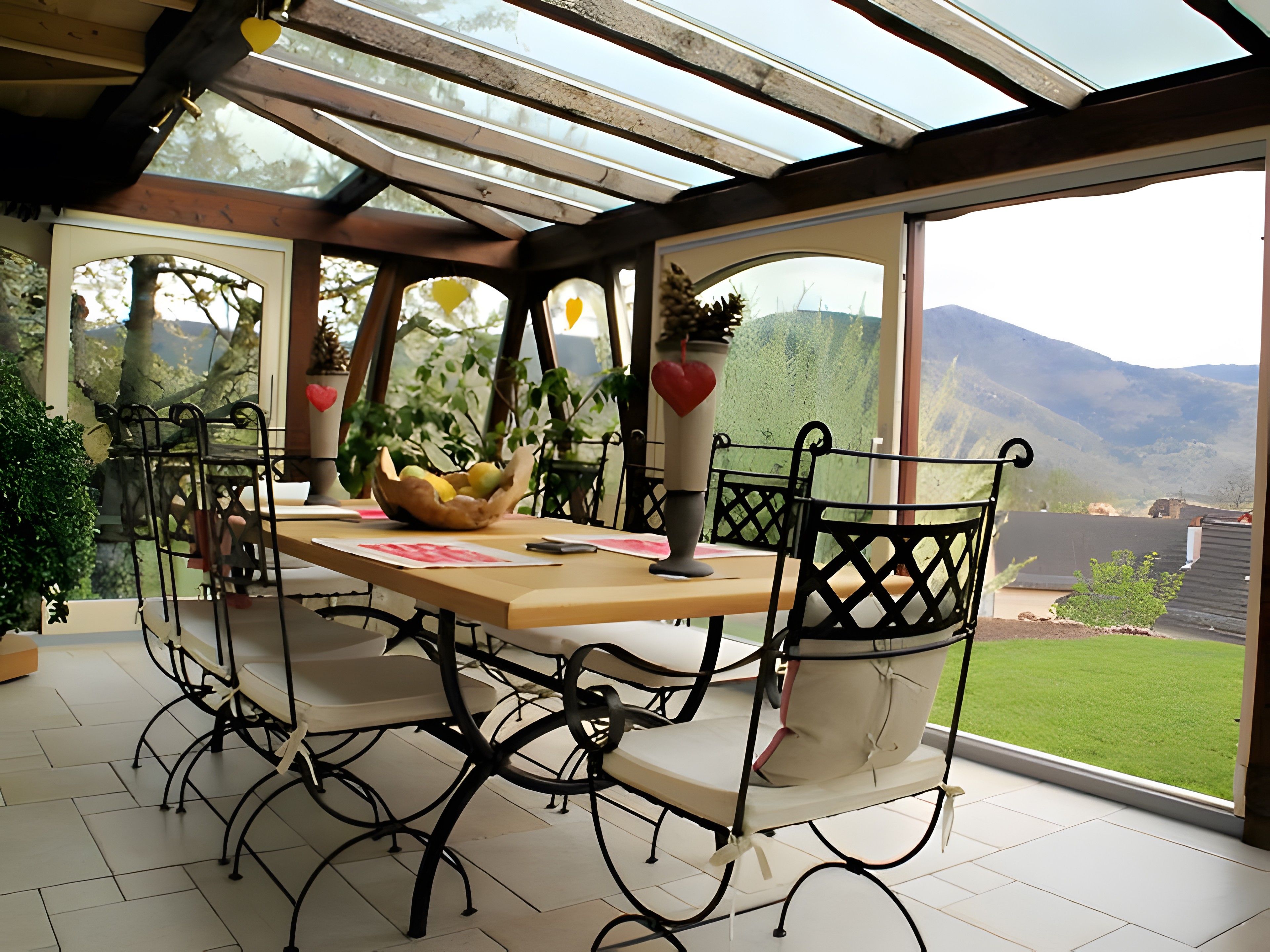 A dining area with a table, chairs, and a view of the outdoors.
