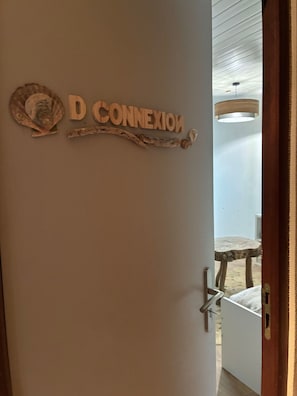 A door with a sign reading 'D CONNECTION' and a rustic decor piece.
