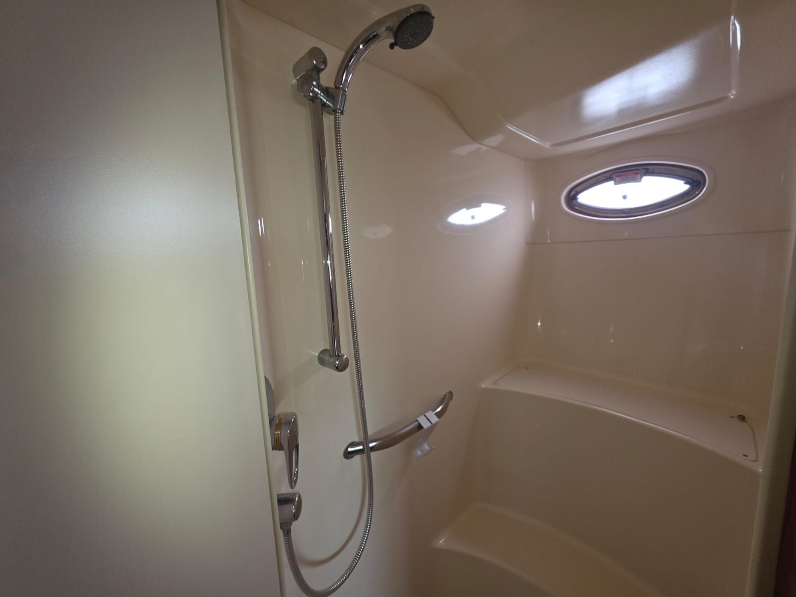 A bathroom with a shower, a toilet, and a sink.