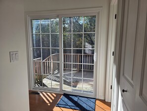 A sliding glass door leading to a wooden deck with a metal railing. - Paradise on Park: New listing! Short walk to Lake Michigan! (Douglas)