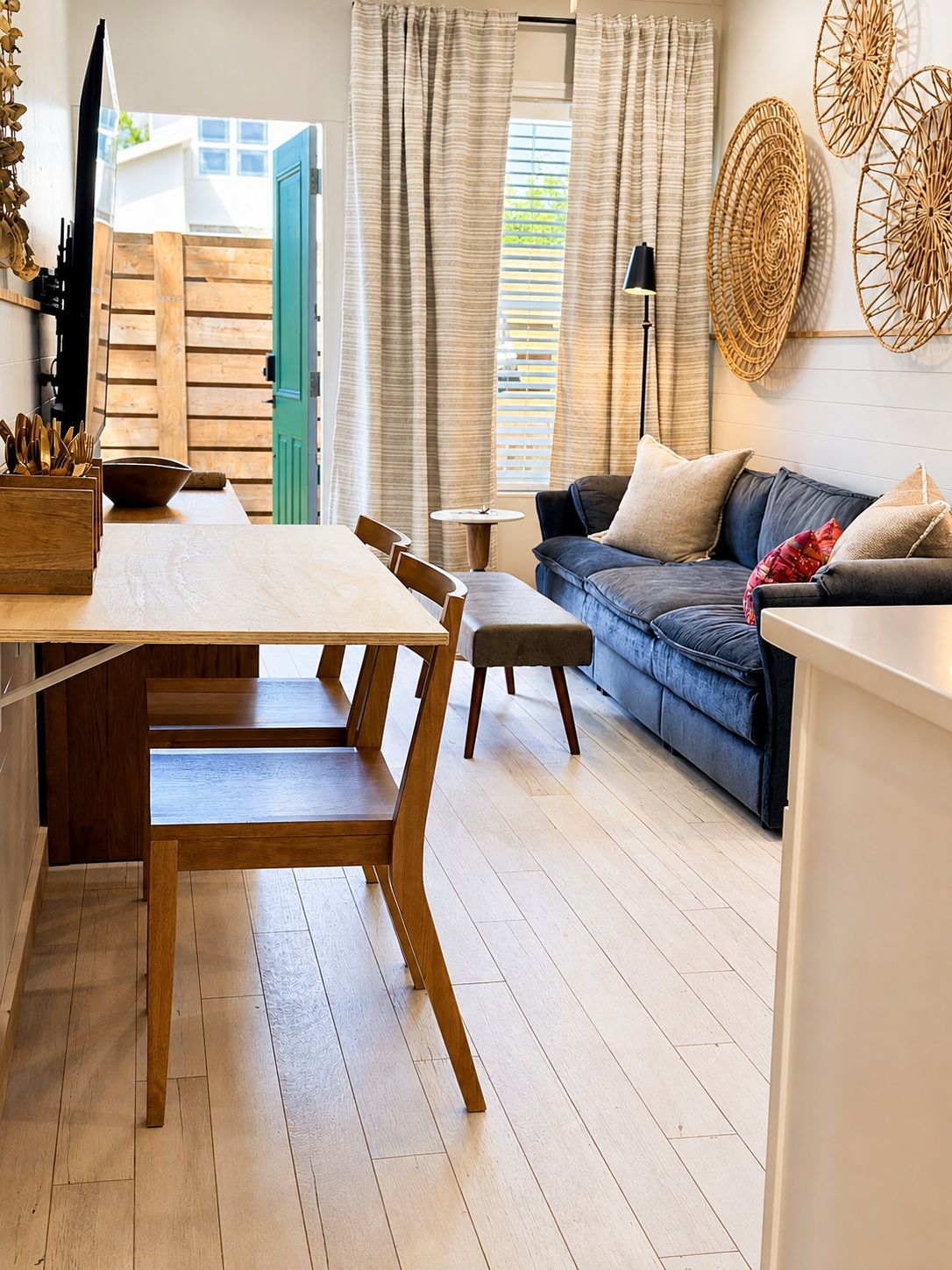 A modern living space with a dining area, a sofa, and a coffee table.