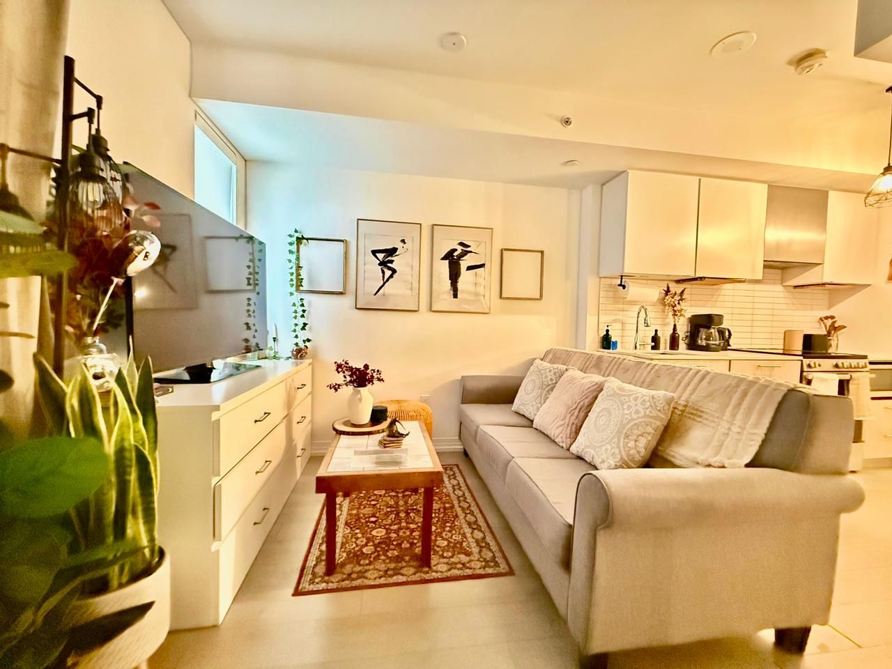 A modern living room with a sofa, coffee table, and decorative items.