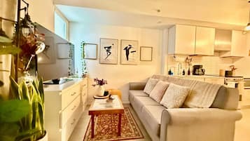 A modern living room with a sofa, coffee table, and decorative items.