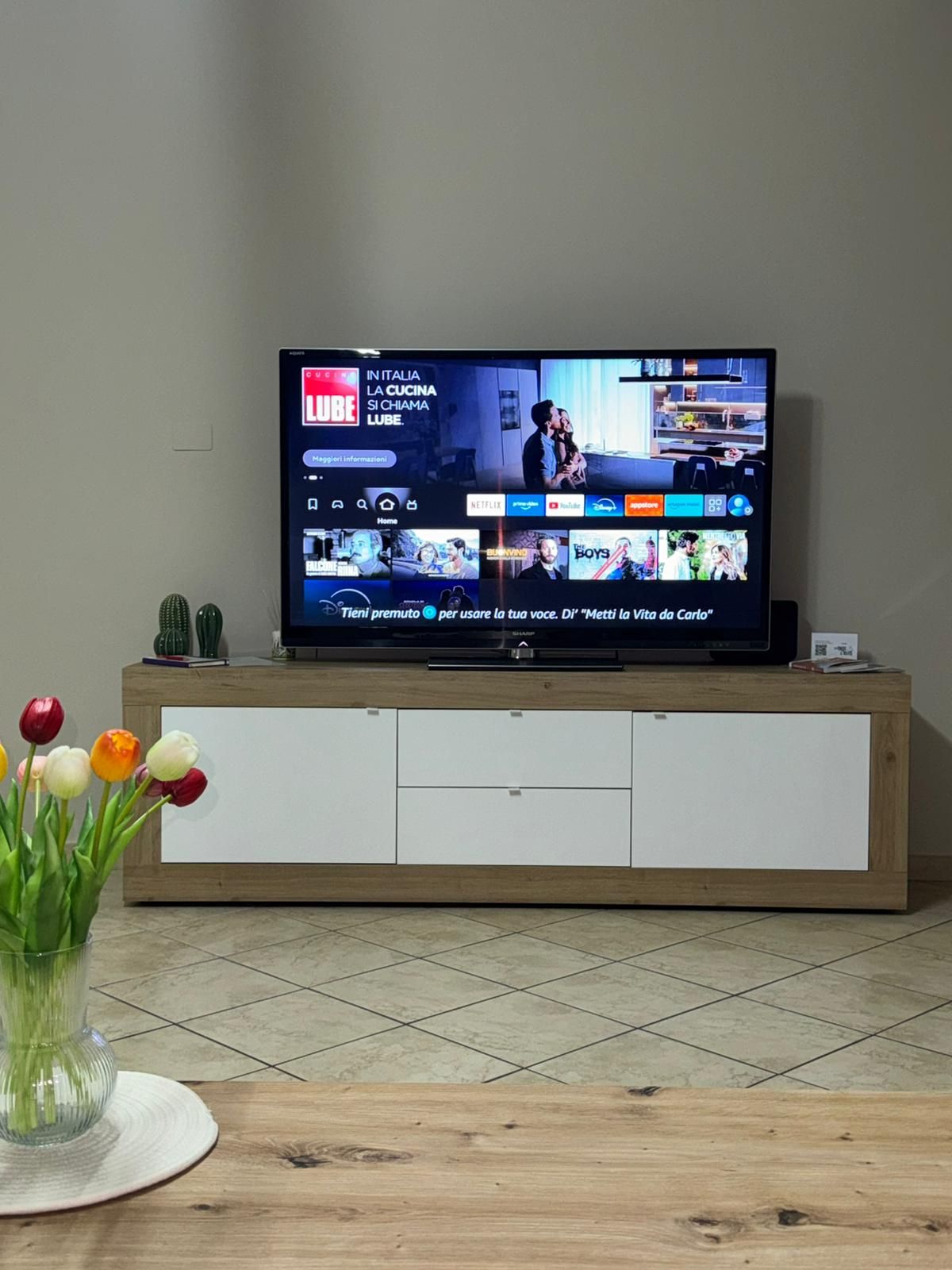 A television displaying a streaming service interface with various content options.