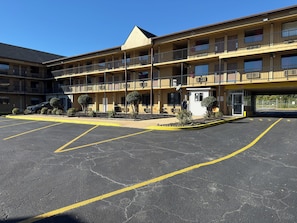 A multi-story motel with a parking lot and a small lobby area. - Executive Inn (Baltimore)