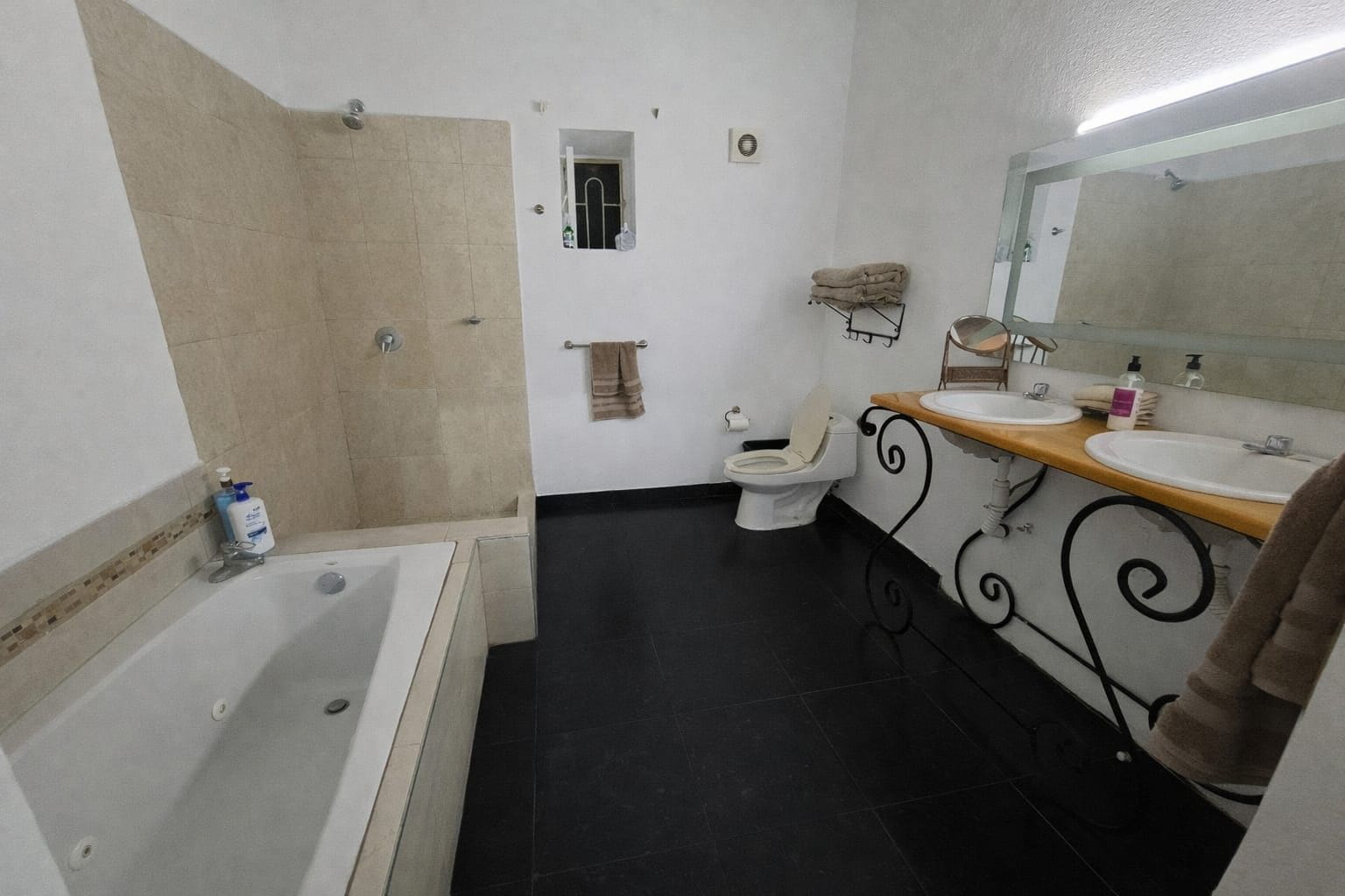 A bathroom with a bathtub, toilet, and sink.