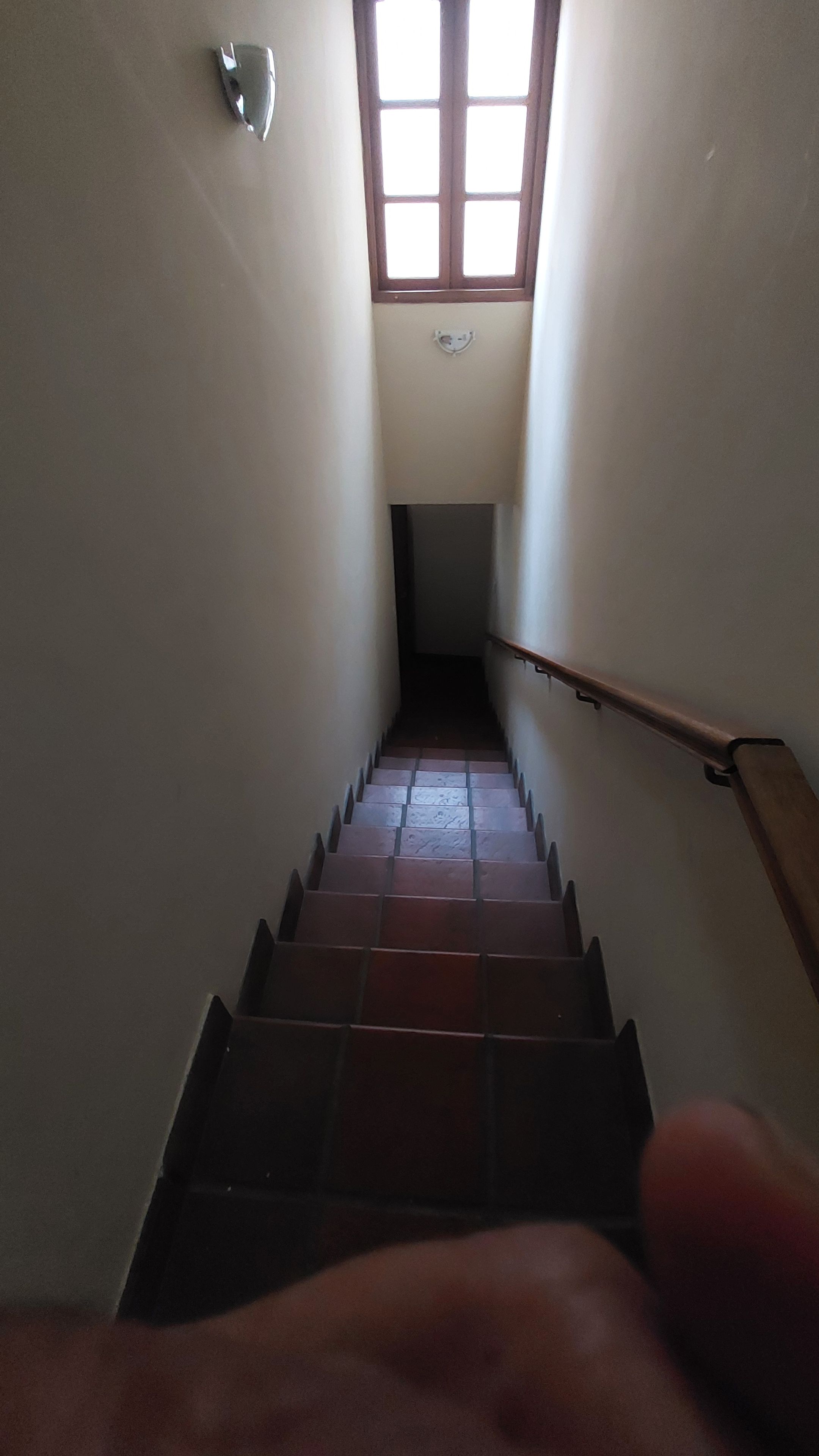 A staircase with a hand reaching towards the top.