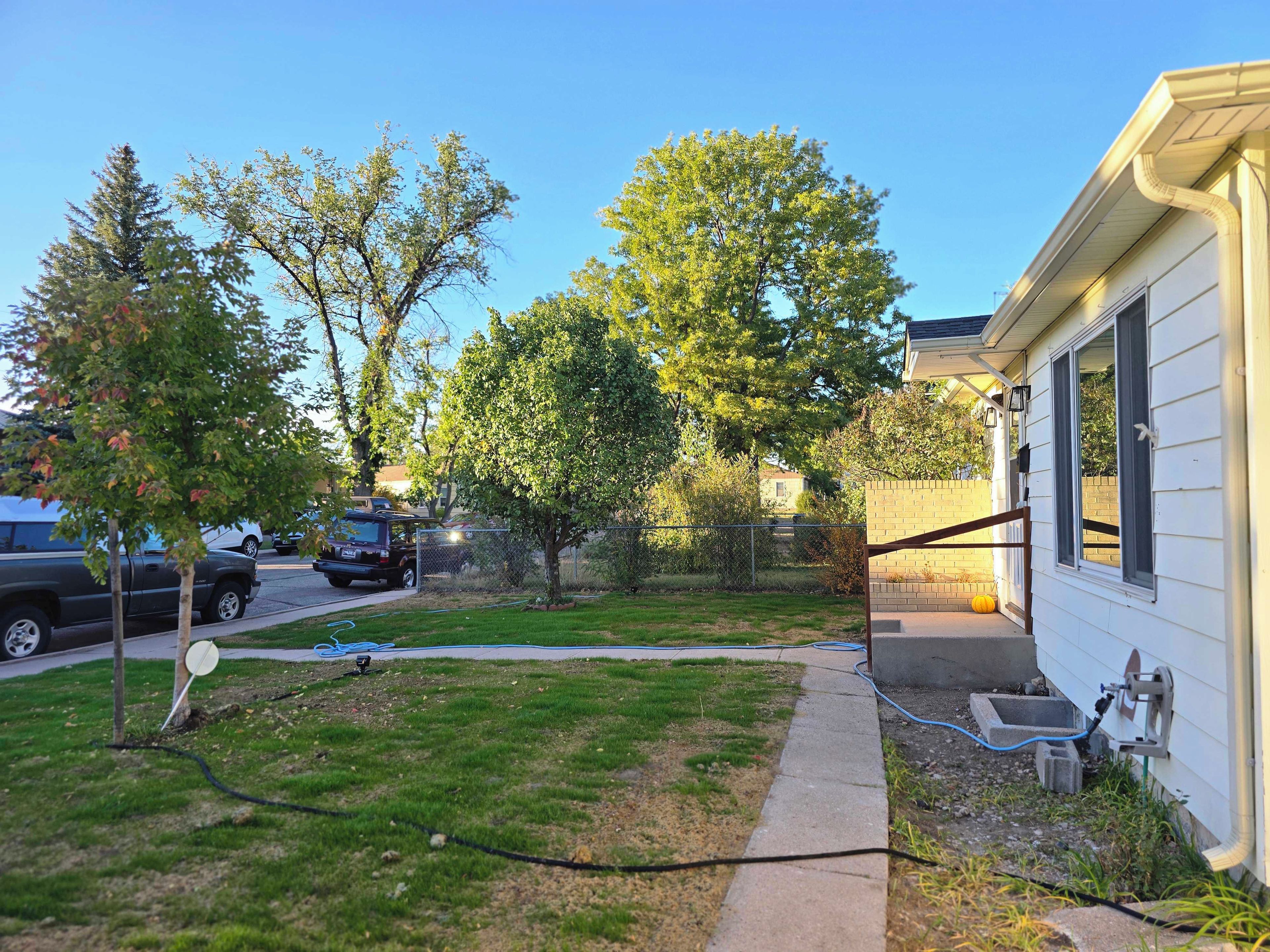 A residential property with a lawn, a driveway, and a garage.