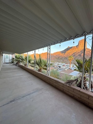 A covered balcony with a view of a mountainous landscape. - Stunning Parker Home with River Views & Privacy! (Parker)