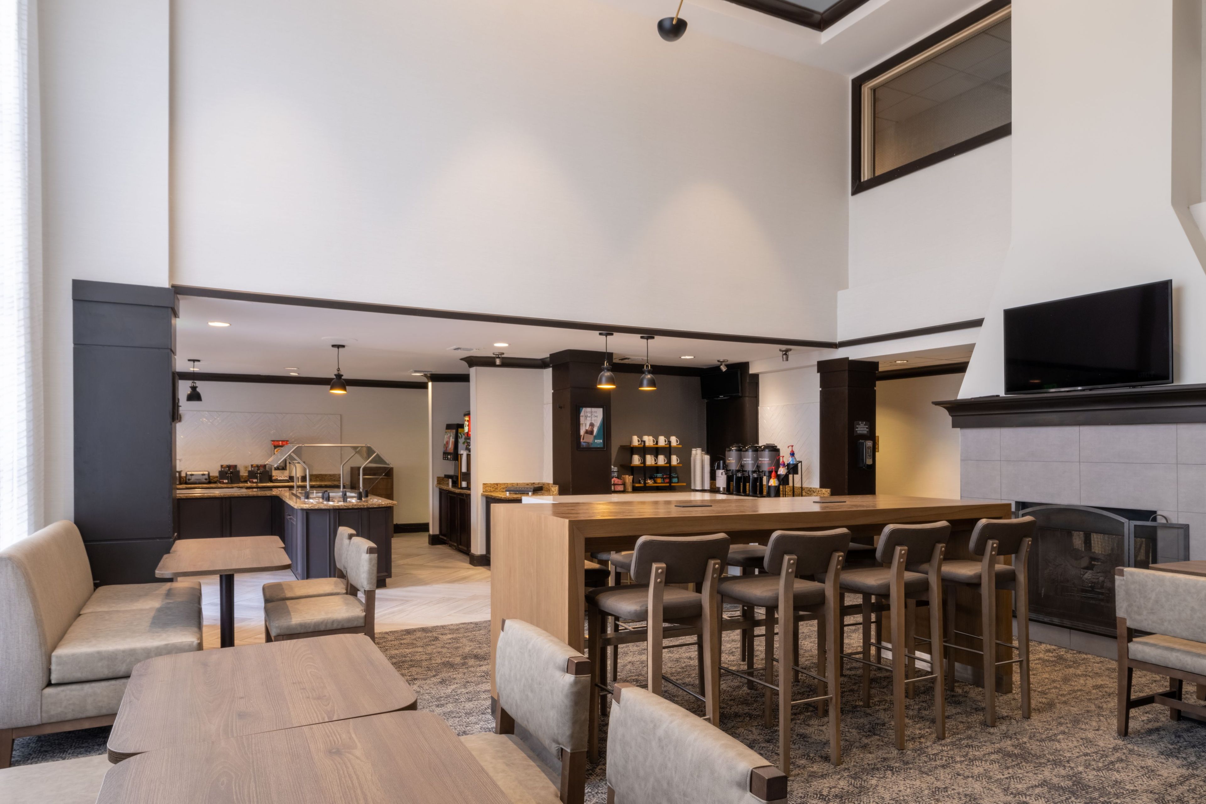 A modern bar area with seating and a coffee station.