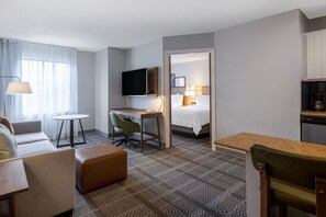 A hotel room with a bed, a desk, a chair, a television, a sofa, and a small table. - 2-Double 1BR Suite w/ Daily Breakfast Incl. + Pool (Dublin)