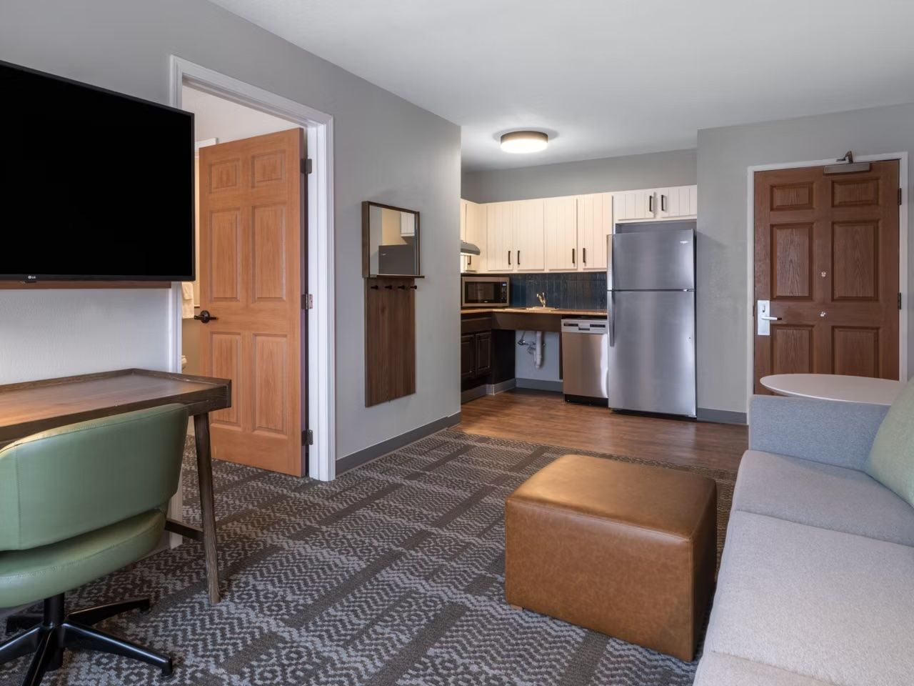 A compact living space with a kitchenette, a dining area, and a seating area.