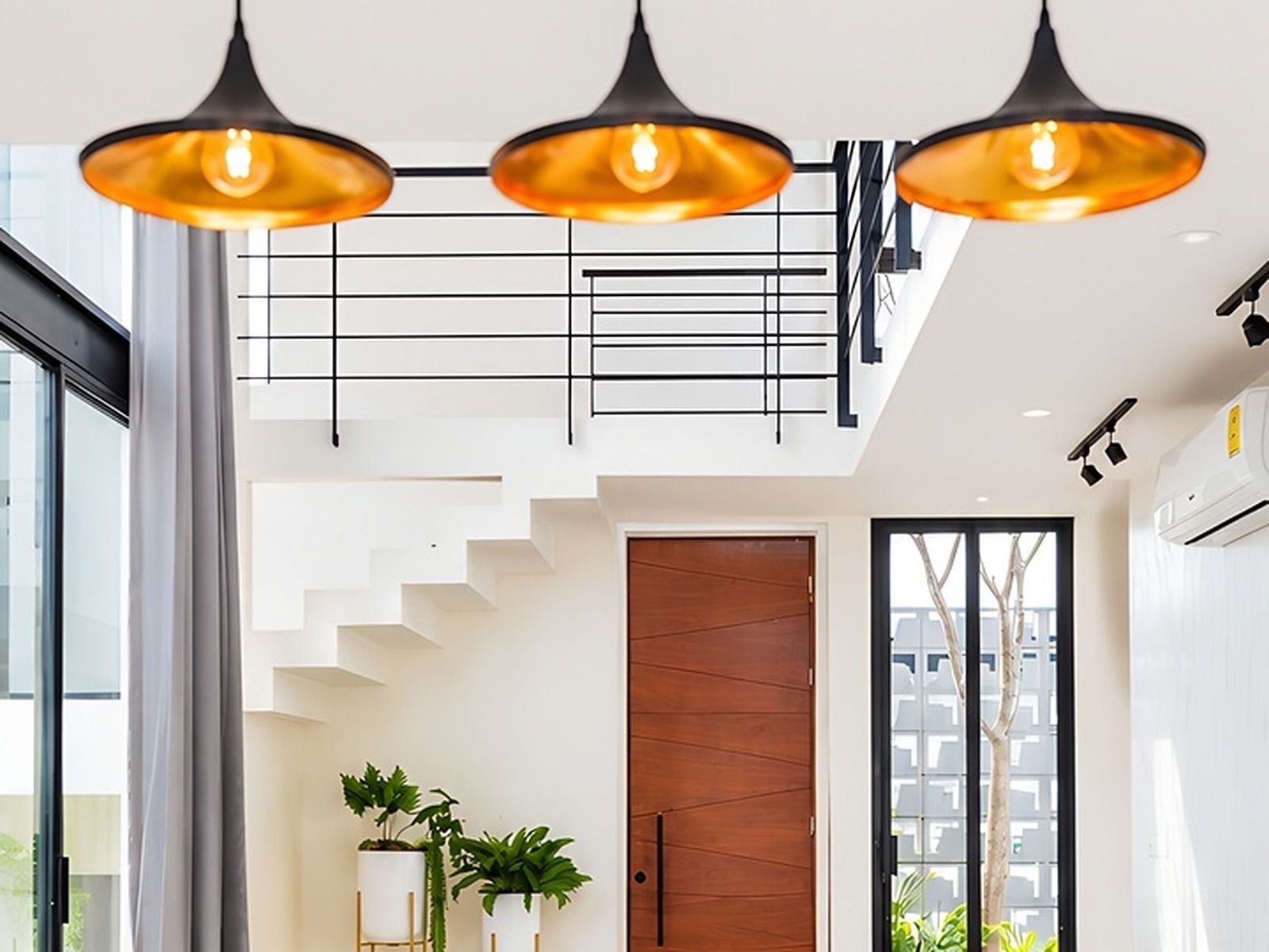 A modern interior with a staircase, pendant lighting, and potted plants.
