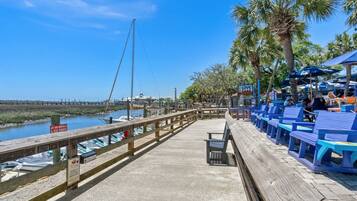 A wooden pier with seating and a view of the water.