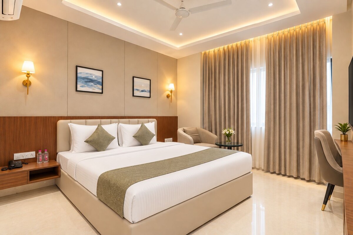 A modern hotel room with a large bed, bedside tables, a desk, and a chair.