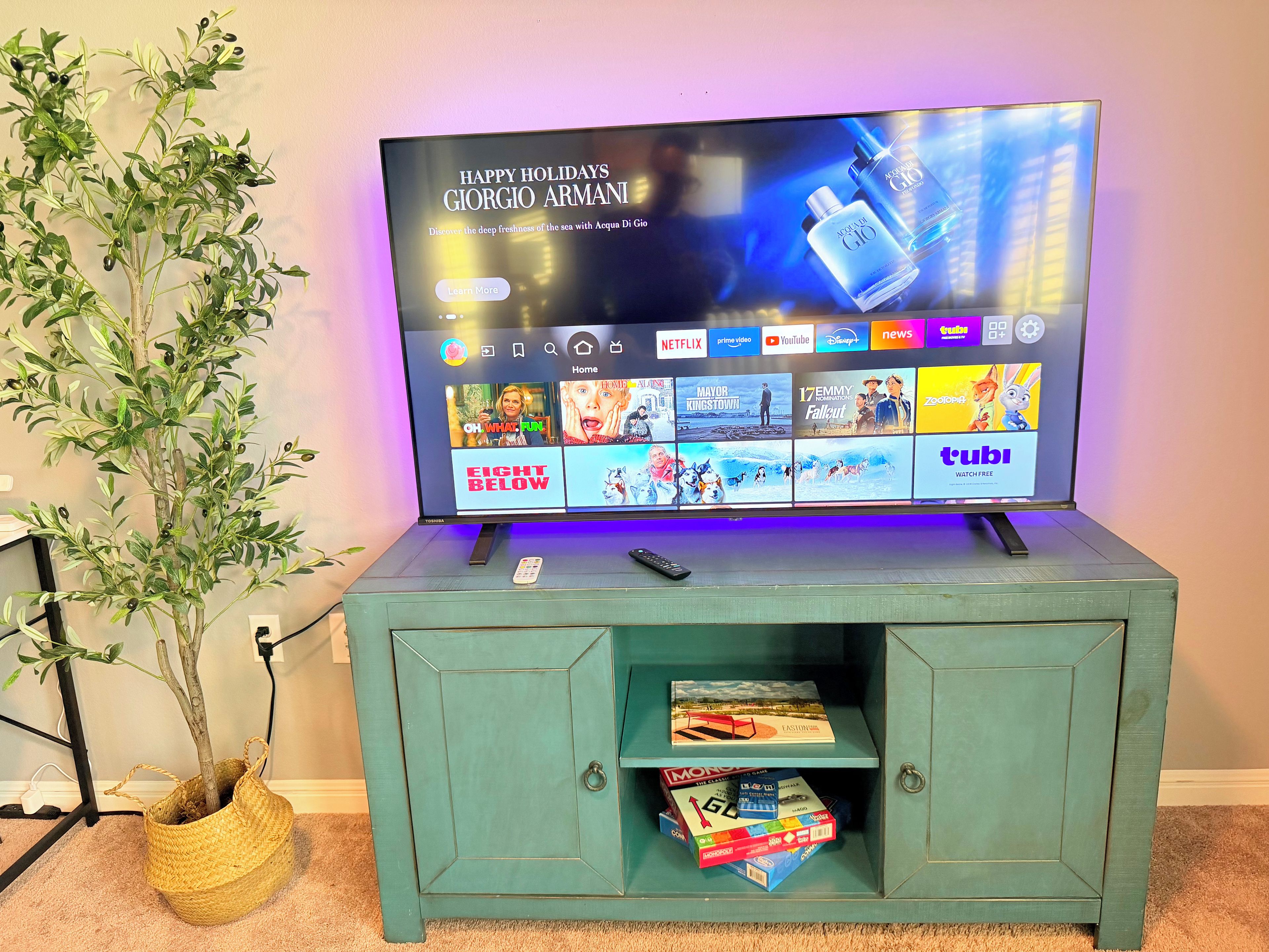 A television displaying a holiday greeting and a selection of streaming services.