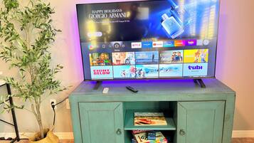 A television displaying a holiday greeting and a selection of streaming services.