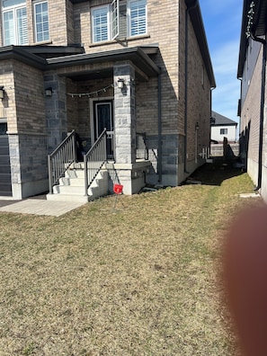 A residential building with a stone facade, a front porch, and a gated entrance. - Welcome to Skies Abode. (Brant)