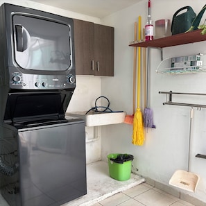 A compact kitchen with a built-in microwave, a sink, and a broom. - New Listing (Juriquilla)