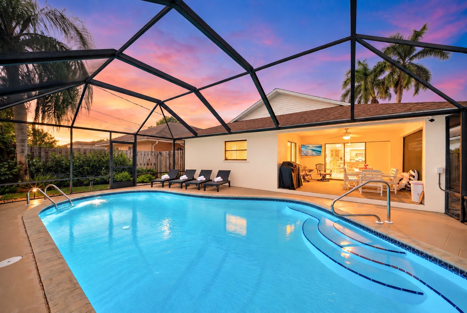 A swimming pool with lounge chairs and a covered patio area.
