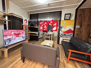 A living room with a television, sofa, and a dining area. - New Listing (Hiroshima)