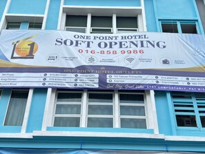 A hotel signboard with contact numbers and a list of hotel outlets. - ONE POINT HOTEL BATU KAWA (Kuching)