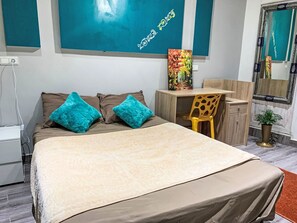 A bedroom with a bed, two pillows, a desk, a chair, a mirror, and a plant. - Jbila Maison by Interhome (Tanger)