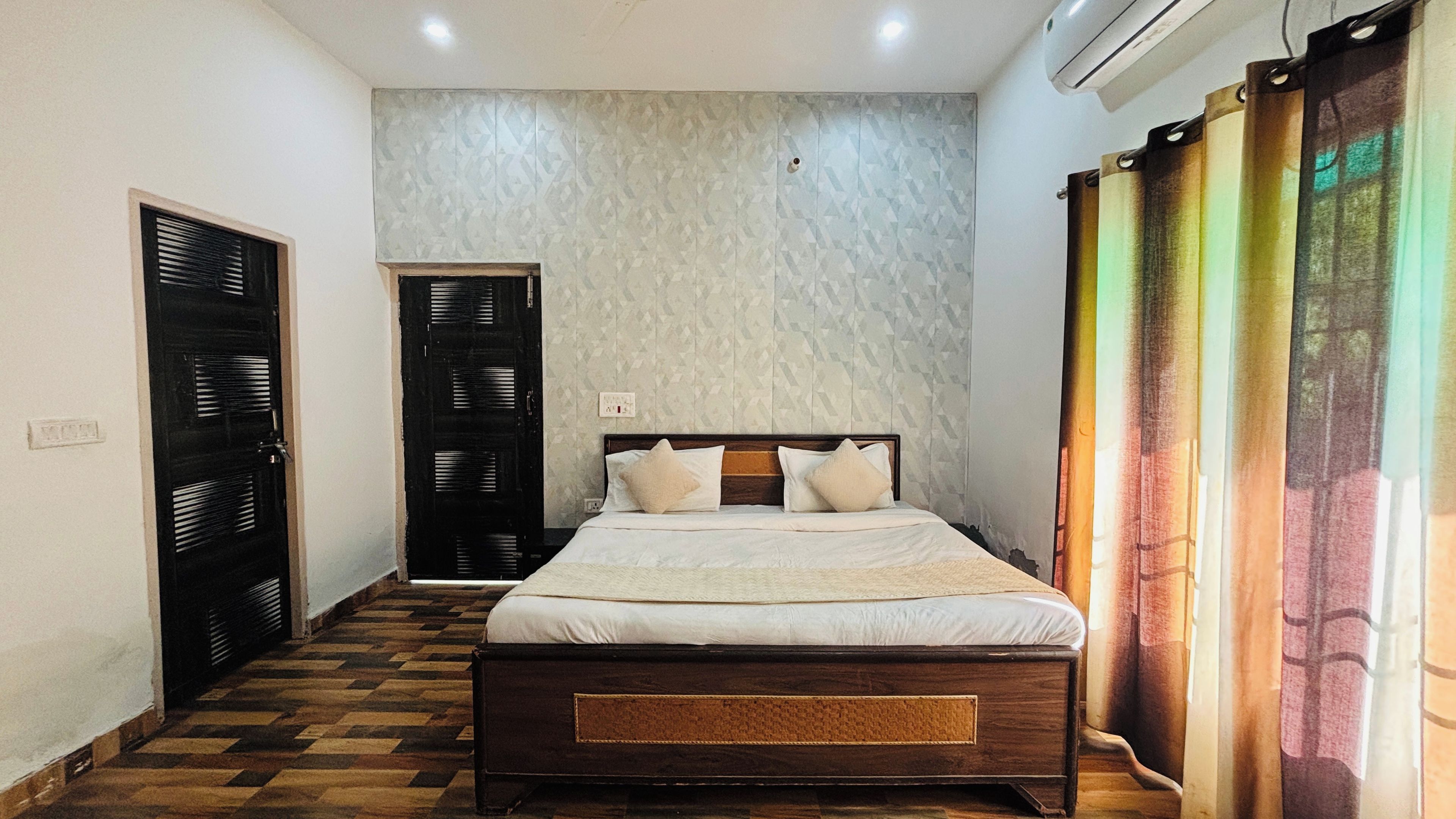 A bedroom with a bed, a wardrobe, and a door.
