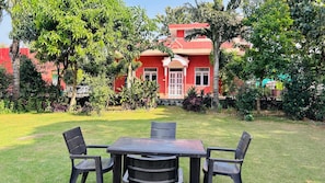 Outdoor dining - Peaceful 4-bedroom farmhouse with AC and private pool near Manesar (Tauru)