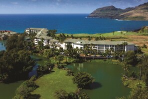 A resort with multiple buildings, a golf course, and a body of water. - Lihue | Family Island Retreat | Pool + Golf | 2BR Condo (Lihue)