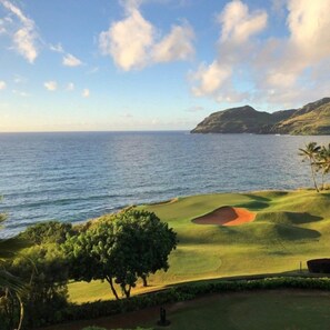 A golf course with a view of the ocean and a mountain in the background. - Lihue | Family Island Retreat | Pool + Golf | 2BR Condo (Lihue)