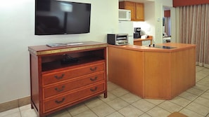 A compact kitchen with a wooden counter, a microwave, a coffee maker, and a flat-screen TV mounted on the wall. - Sedona | Garden Oasis | Spa, Pool & Village Access (Sedona)