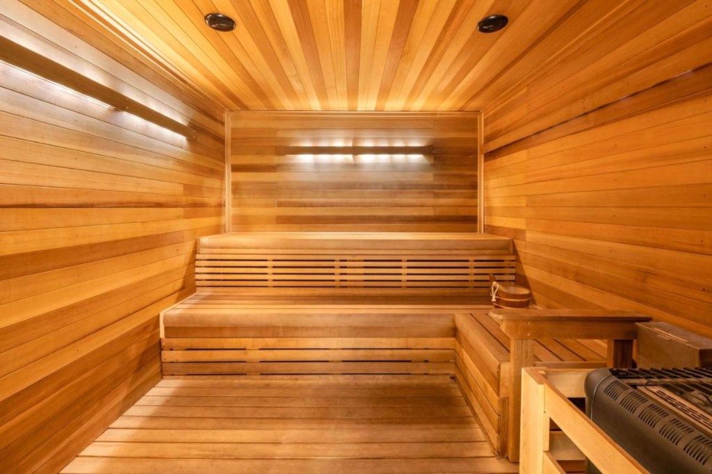 A wooden sauna with benches and a bench with a towel.