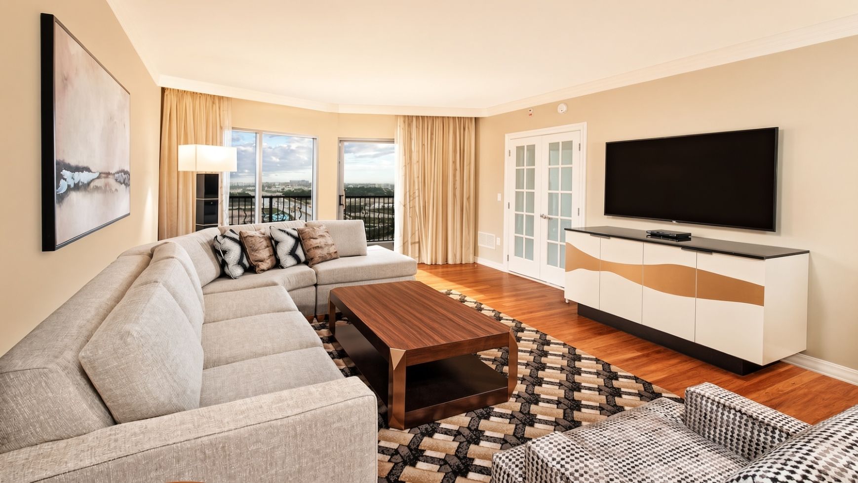 A modern living room with a sofa, coffee table, and TV.
