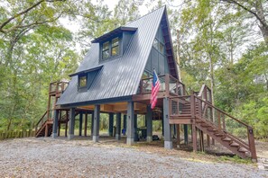 A multi-level cabin with a metal roof, wooden deck, and a flagpole. - Walk to Choctawhatchee River! A-Frame Cabin Escape (Ponce de Leon)
