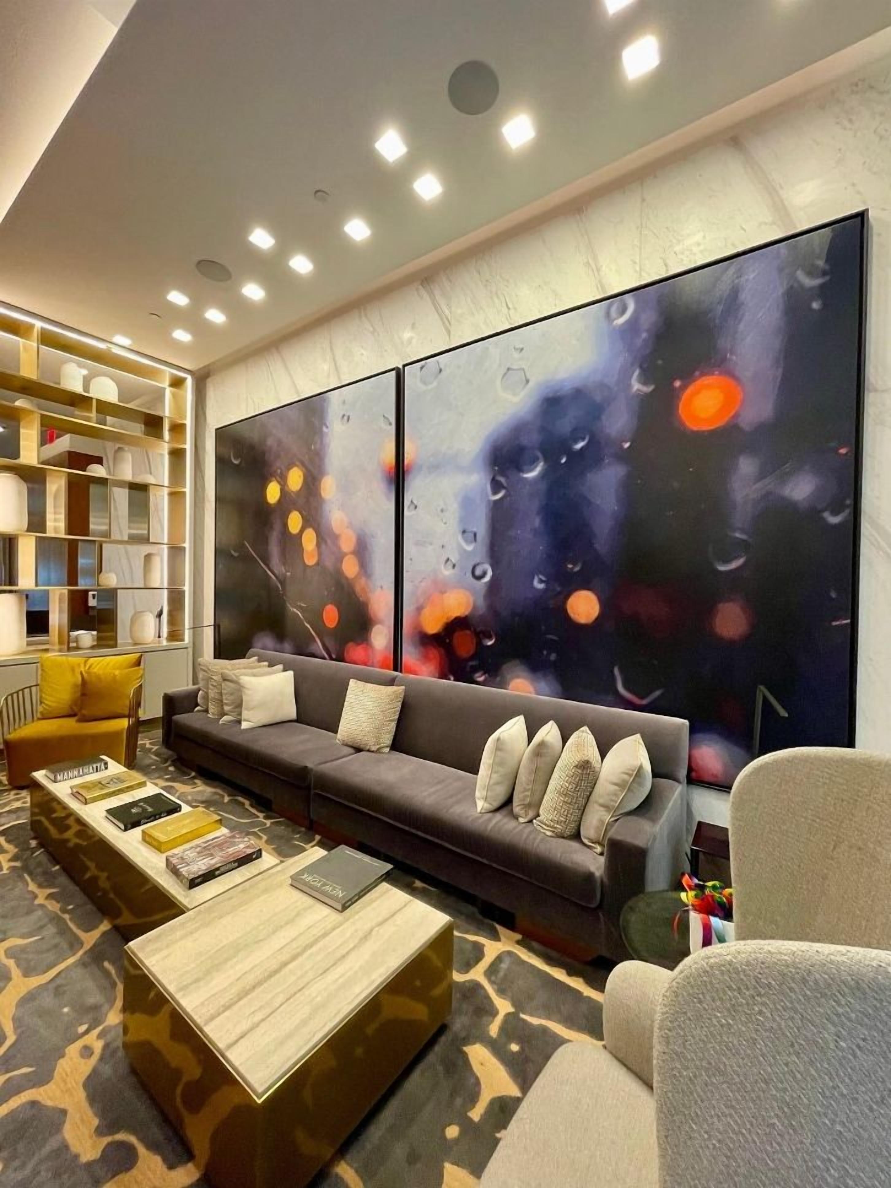 A modern living room with a sectional sofa, a coffee table, and a bookshelf.