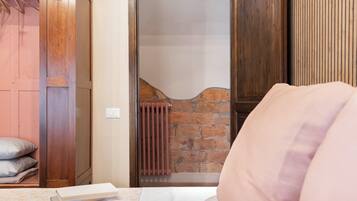 A room with a bed, a radiator, and a wooden door.