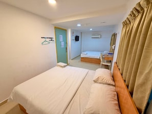 A hotel room with two beds, a desk, and a bathroom visible through an open door. - De Uptown Hotel Subang Jaya by Easy Nap (Subang Jaya)