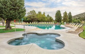 A hot tub area with a pool, lounge chairs, and trees. - Redmond | High Desert Comfort Escape | Pool + Trails (Redmond)
