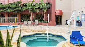 A swimming pool with lounge chairs, a lifeguard stand, and a pool rules sign. - Pompano Beach | Relaxed Pool Retreat | Pool + Beach (Pompano Beach)