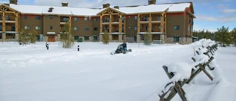 A multi-story hotel with a snow-covered courtyard and wooden exterior.