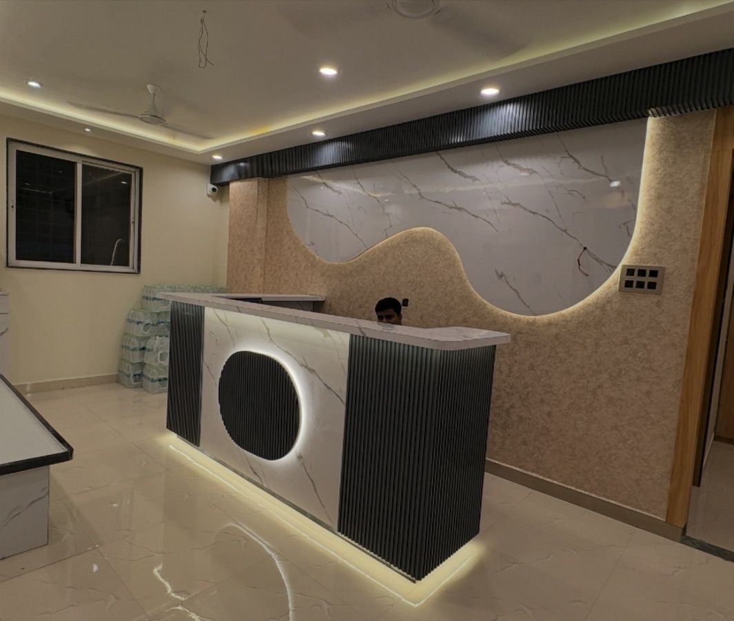Un mostrador de recepción con una pared de mármol y diseño moderno.