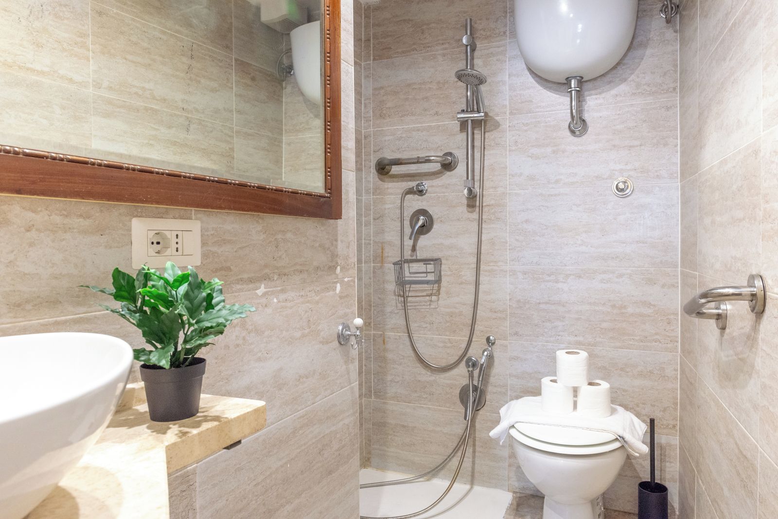 A bathroom with a shower, toilet, and sink.