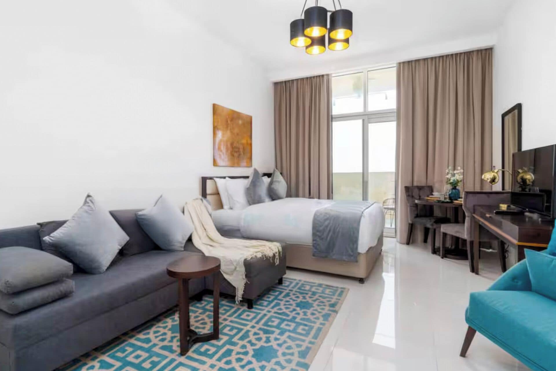 Une chambre d’hôtel moderne équipée d’un lit, d’un canapé, d’un bureau et d’une grande fenêtre.