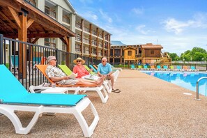 A poolside area with lounge chairs and a pool. - Step Free Access 2BR Condo • Balcony • Pools • Walk to Branson Landing (Branson)